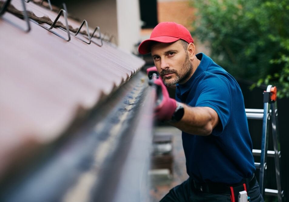 Male,Worker,Inspecting,The,Cleanliness,Of,The,Gutters,Before,Autumn