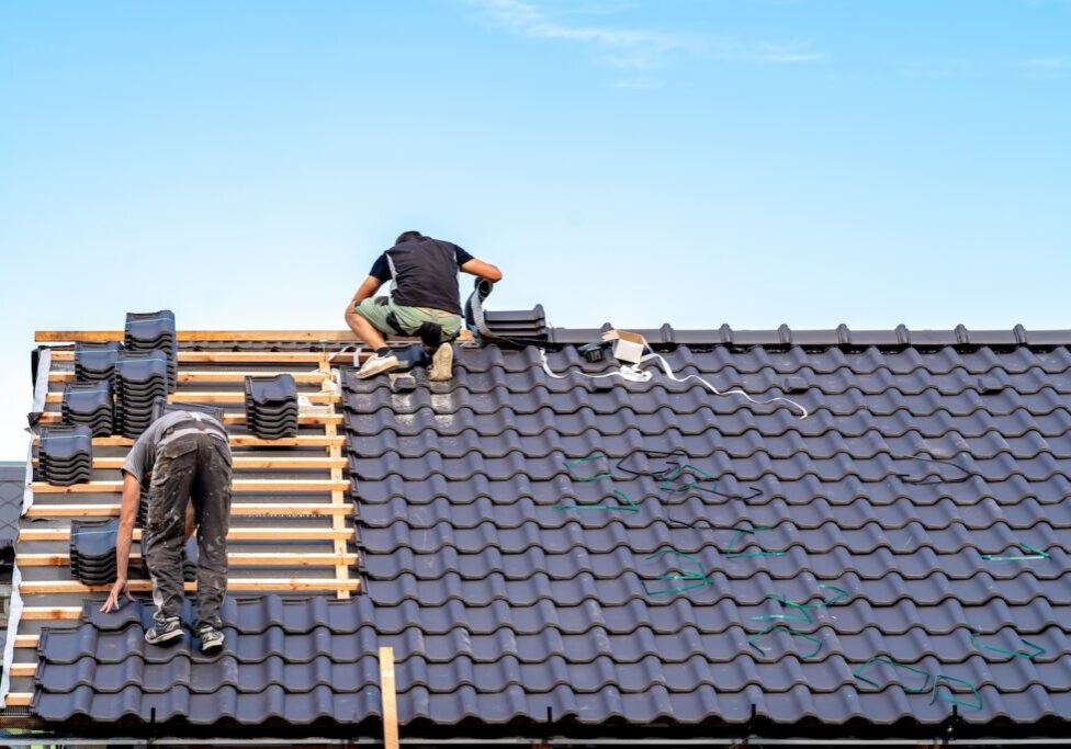 craftsman builds a new roof from ceramic tiles