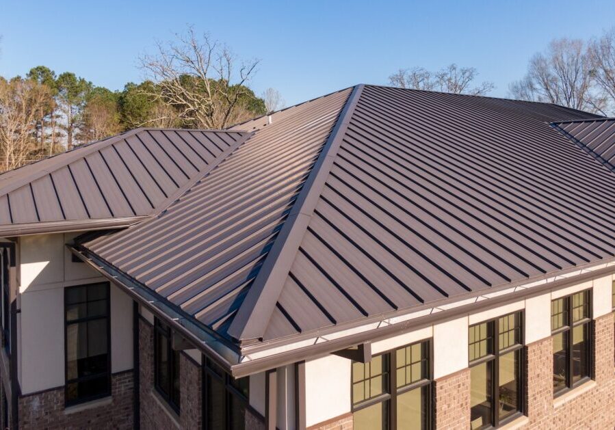 Sunny Daytime Drone Images Of a Brown Standing Seam Metal Roof On A Commercial Building: No People, Architecture, Industry