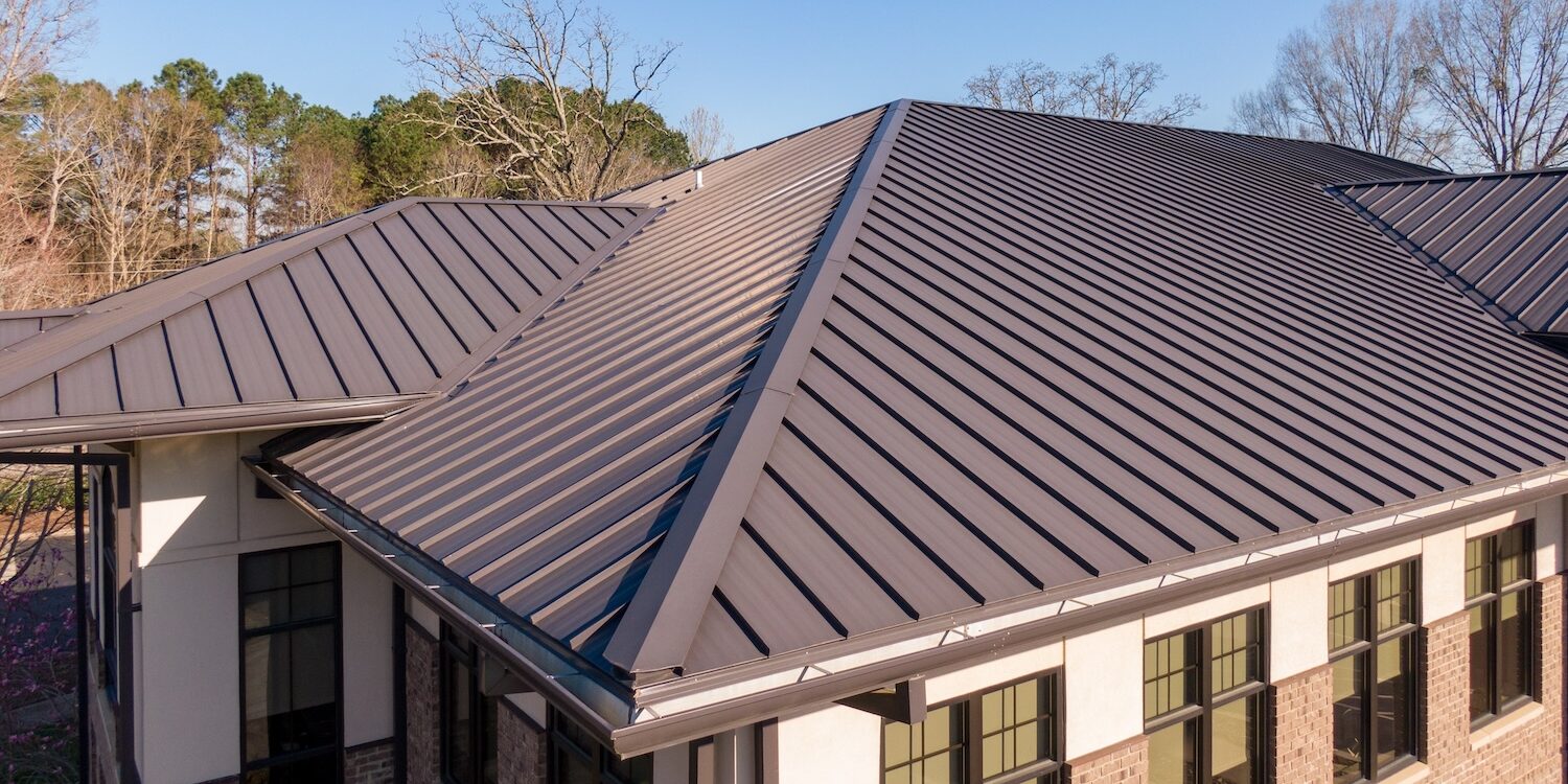 Sunny Daytime Drone Images Of a Brown Standing Seam Metal Roof On A Commercial Building: No People, Architecture, Industry